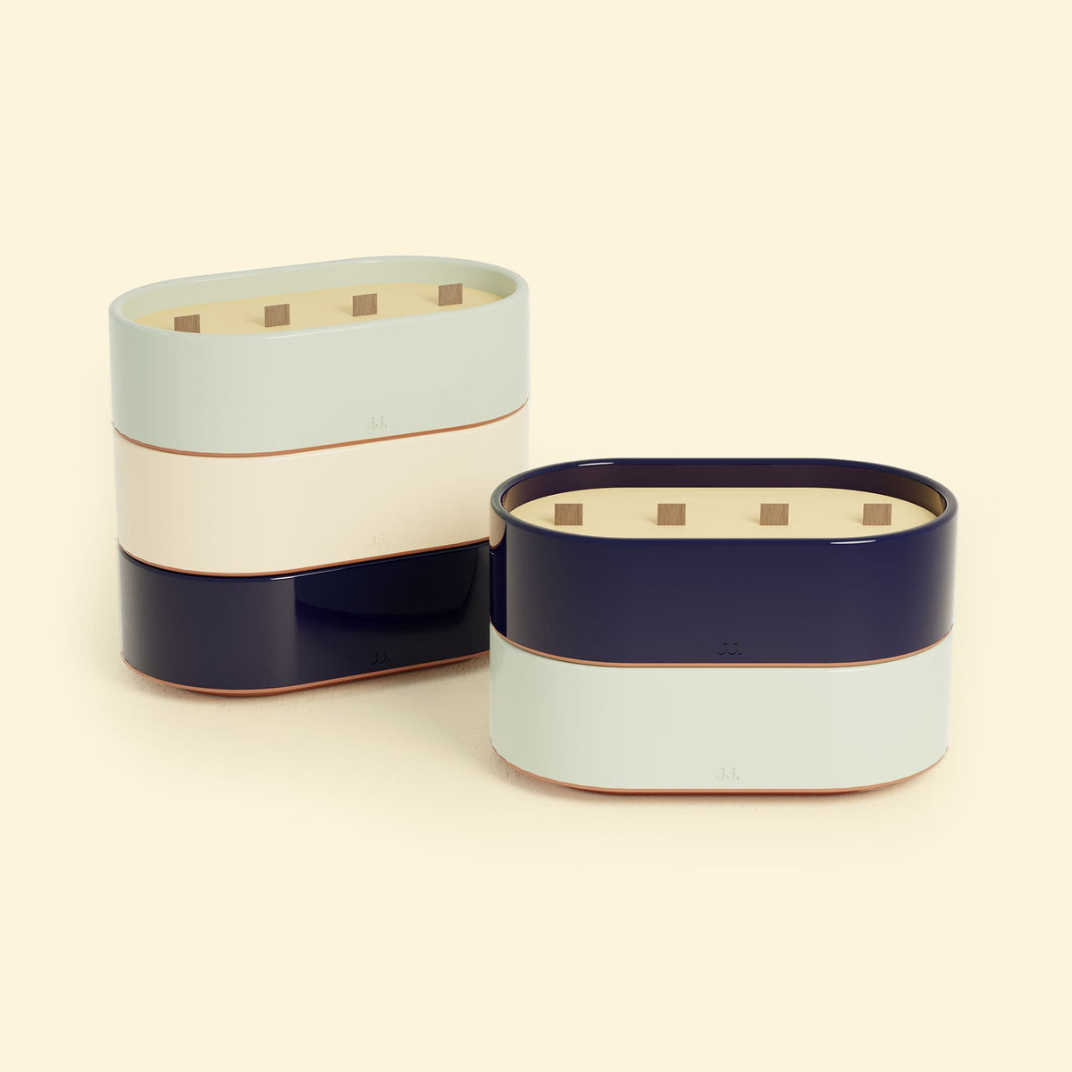 Bougies Totem L Vert d’eau – Citronnelle & Eucalyptus et Bleu marine – Citronnelle & Sel de mer, deux grandes bougies ovales à triple mèche en bois, posées sur un fond beige clair.